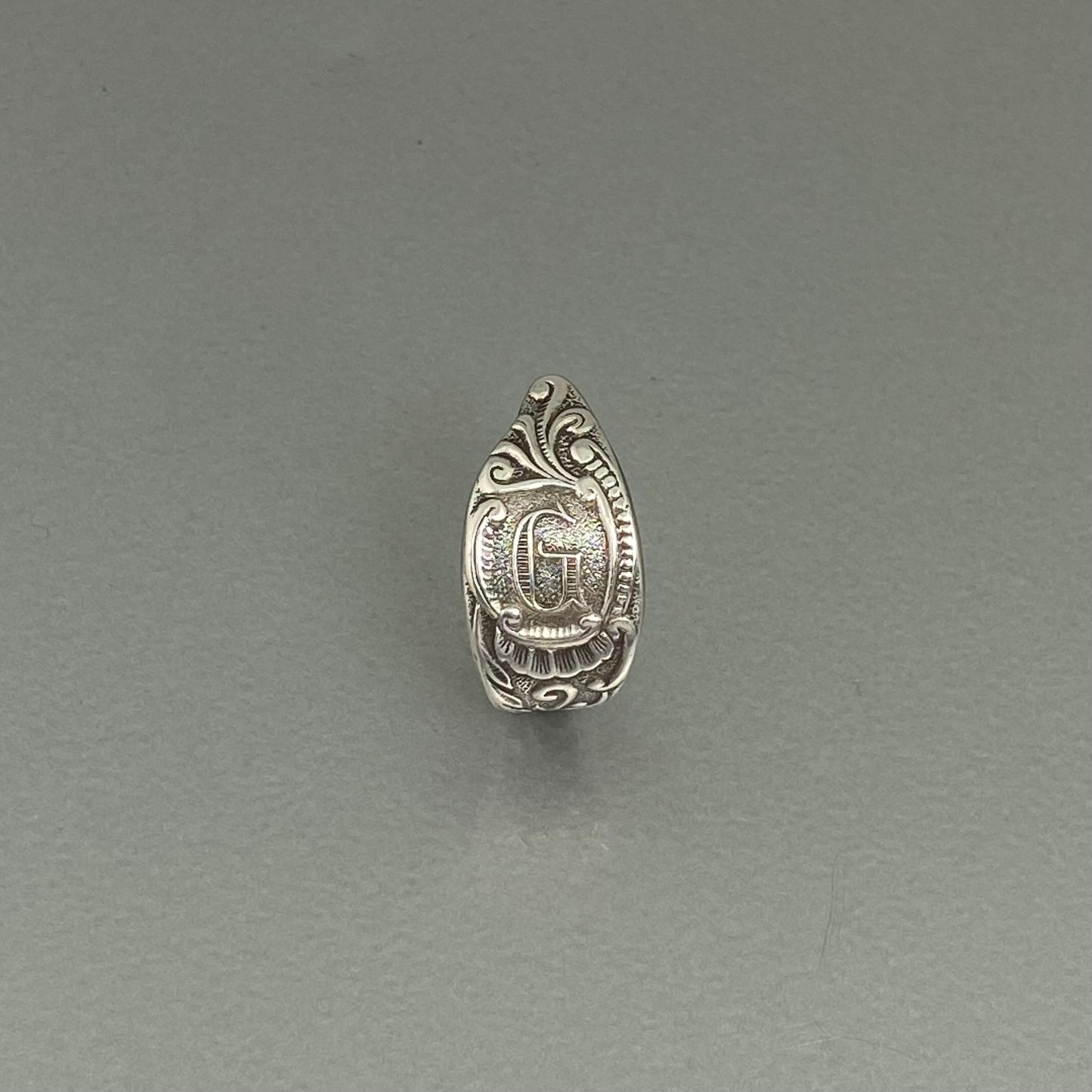 Initial G curly